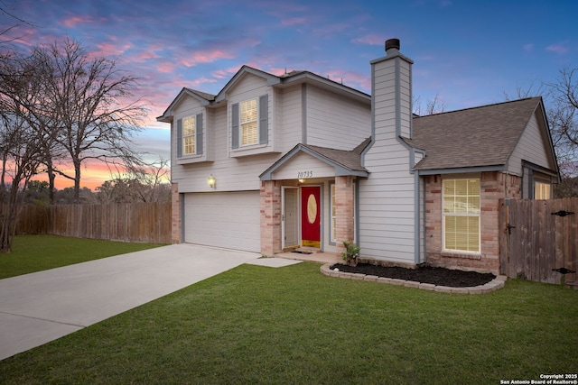 view of front of property featuring a garage and a lawn