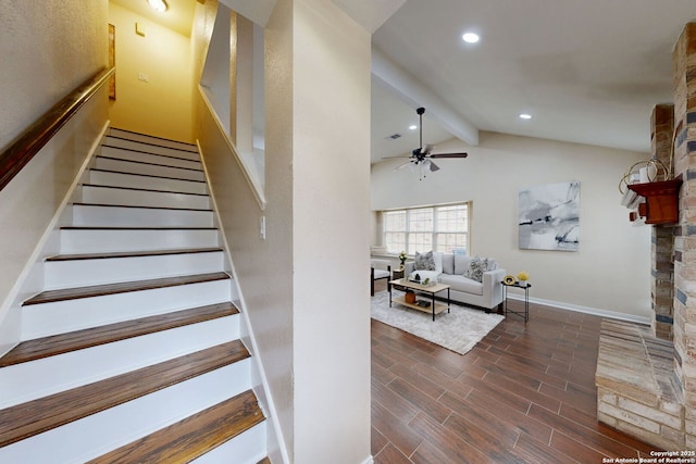 staircase featuring vaulted ceiling with beams, a fireplace, and ceiling fan