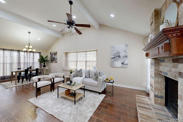 living room with vaulted ceiling with beams, ceiling fan with notable chandelier, and a fireplace