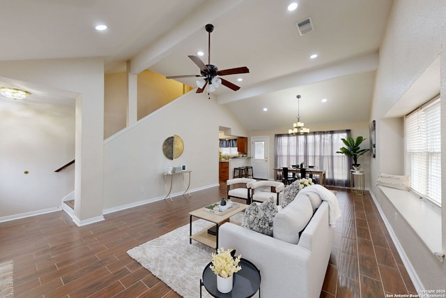 living room with beamed ceiling, ceiling fan with notable chandelier, and high vaulted ceiling