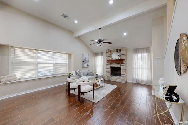 living room featuring high vaulted ceiling, dark hardwood / wood-style floors, beamed ceiling, ceiling fan, and a fireplace