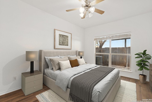 bedroom with a ceiling fan, baseboards, and wood finished floors