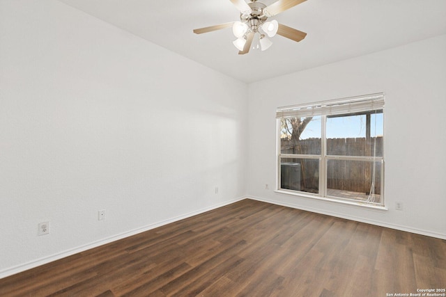 unfurnished room featuring dark wood-style floors, ceiling fan, and baseboards