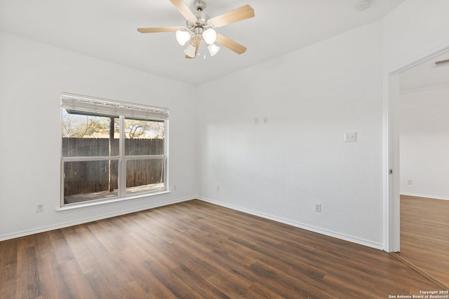 spare room with ceiling fan, baseboards, and wood finished floors