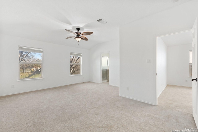 empty room with a ceiling fan, visible vents, light carpet, and baseboards