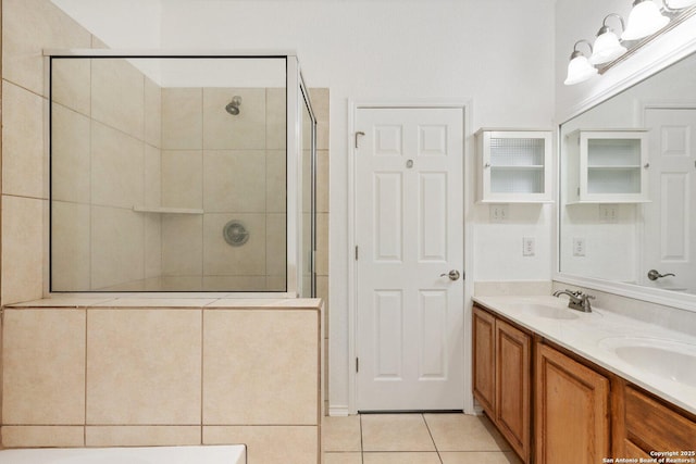 full bath featuring a stall shower, a sink, and tile patterned floors