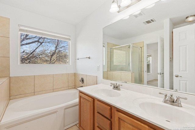 full bath featuring a bath, a sink, visible vents, and a shower stall