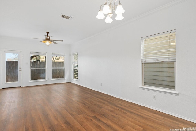 empty room featuring baseboards, ceiling fan with notable chandelier, wood finished floors, and crown molding