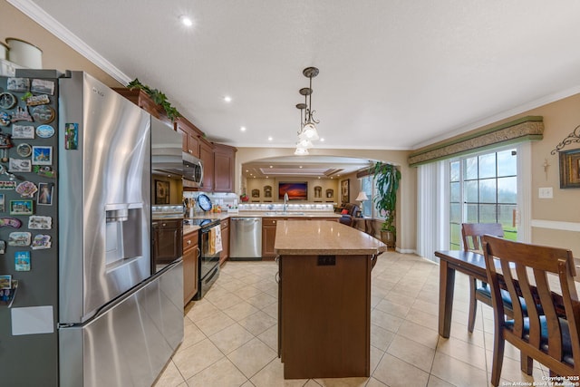 kitchen featuring stainless steel appliances, ornamental molding, hanging light fixtures, and light tile patterned floors