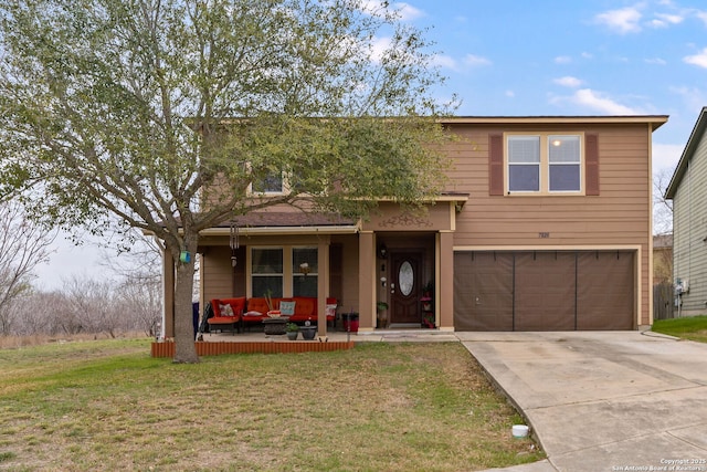 view of front of house featuring a garage, a front yard, and covered porch