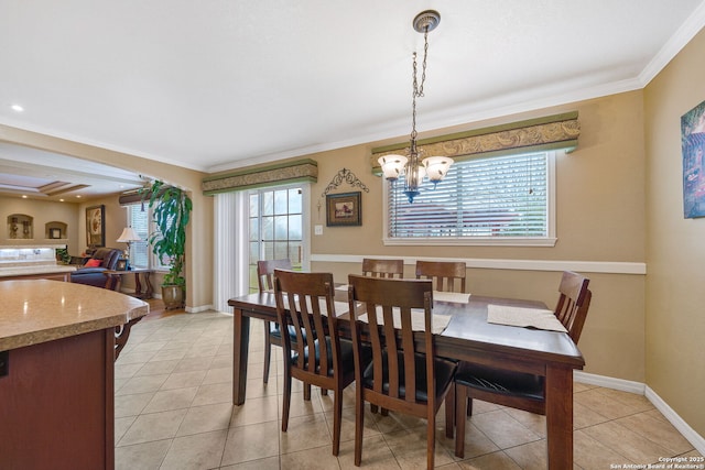 dining space featuring ornamental molding, light tile patterned flooring, and a chandelier