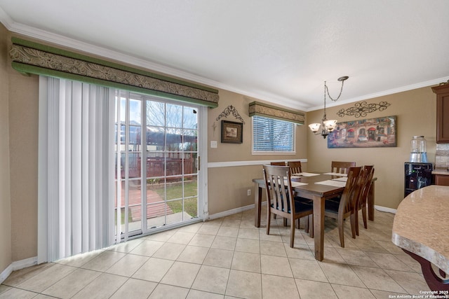 tiled dining area featuring a healthy amount of sunlight, ornamental molding, and a chandelier