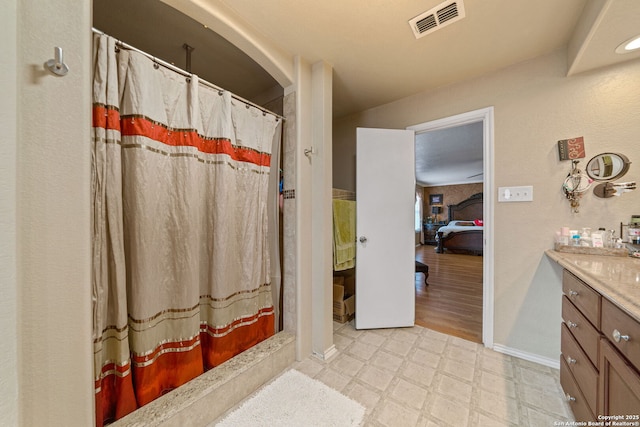 bathroom featuring a shower with curtain and vanity