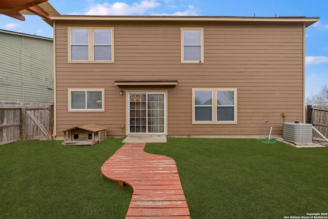 rear view of house featuring a deck, a lawn, and central air condition unit