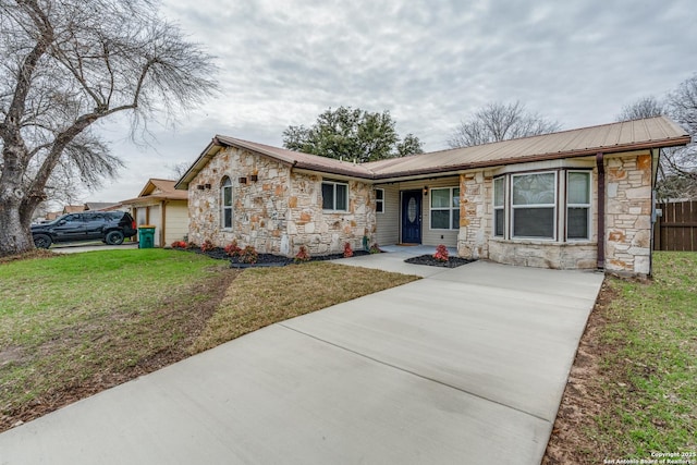 ranch-style house featuring a garage and a front yard