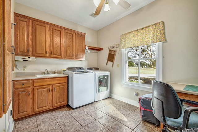 laundry area with sink, cabinets, light tile patterned floors, ceiling fan, and independent washer and dryer