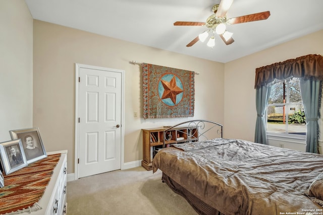 bedroom featuring light colored carpet and ceiling fan