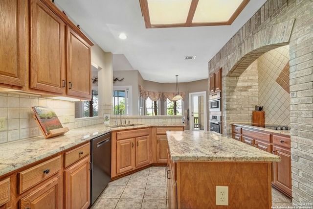 kitchen with sink, dishwasher, light stone countertops, decorative light fixtures, and kitchen peninsula