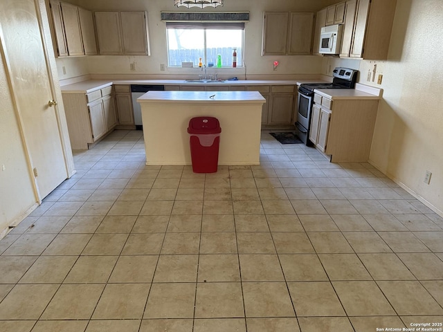 kitchen with a center island, stainless steel appliances, light brown cabinets, and sink