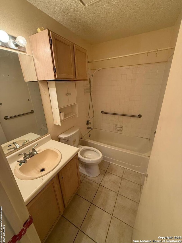 full bathroom with vanity, a textured ceiling, tiled shower / bath combo, toilet, and tile patterned floors