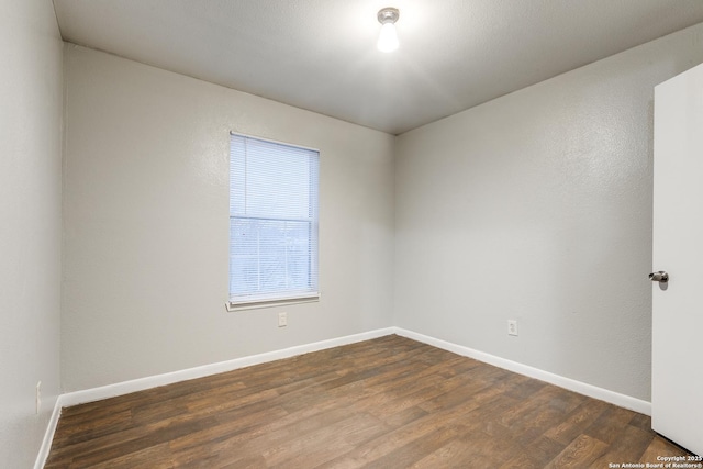 spare room with dark hardwood / wood-style floors