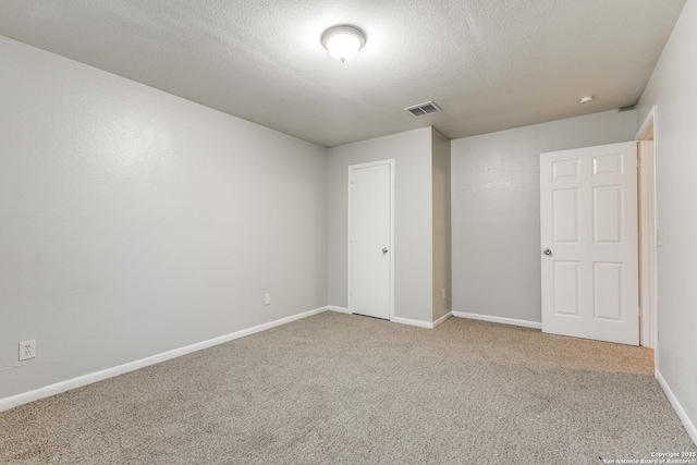 unfurnished bedroom with carpet and a textured ceiling