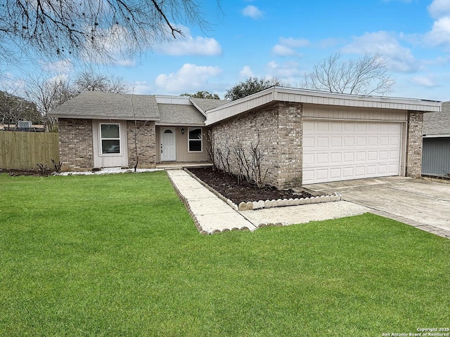 single story home with a garage and a front lawn