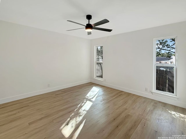 spare room with light hardwood / wood-style flooring and ceiling fan