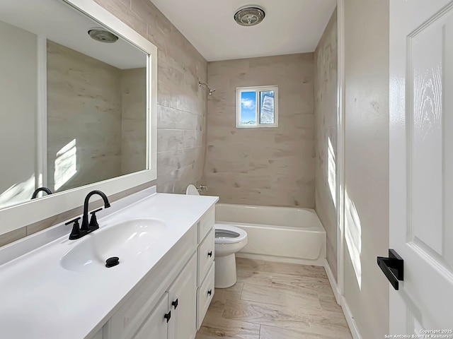 full bathroom with tiled shower / bath combo, vanity, and toilet