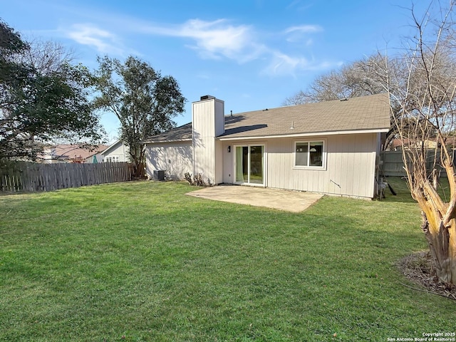 back of property with cooling unit, a patio, and a lawn