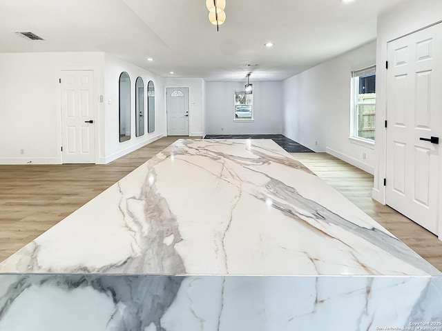 foyer featuring plenty of natural light and light hardwood / wood-style floors