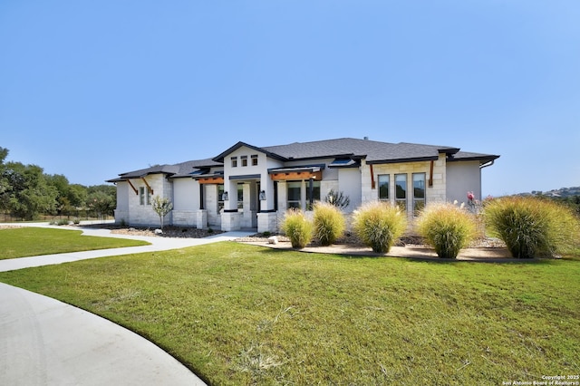 prairie-style home with a front lawn