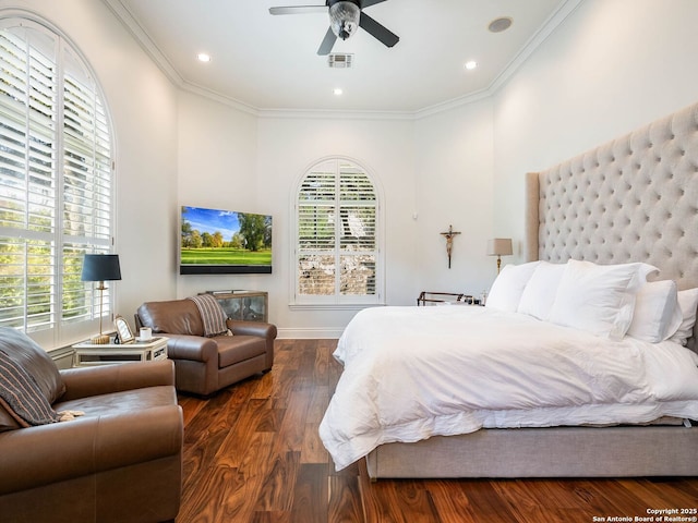 bedroom with ornamental molding, dark hardwood / wood-style floors, and ceiling fan