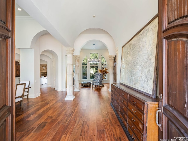 foyer featuring decorative columns and dark hardwood / wood-style floors