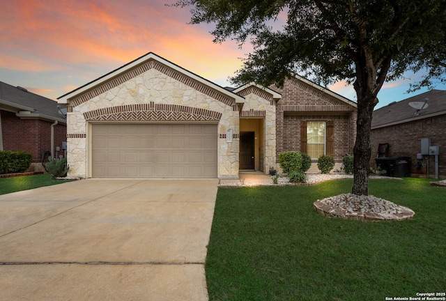 view of front of house with a garage and a lawn