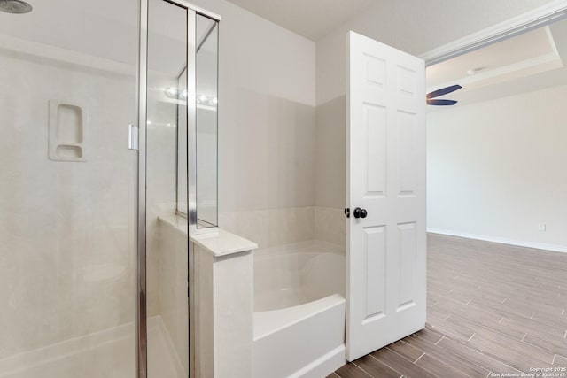 bathroom featuring hardwood / wood-style flooring and separate shower and tub