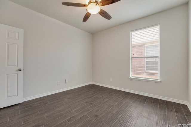 spare room with dark hardwood / wood-style floors and ceiling fan