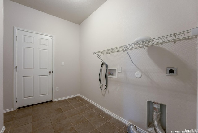 clothes washing area featuring hookup for a gas dryer, washer hookup, dark tile patterned floors, and hookup for an electric dryer