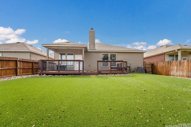 back of property with a lawn, a deck, and central air condition unit