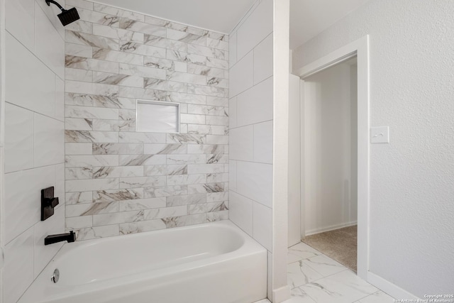 bathroom featuring tiled shower / bath