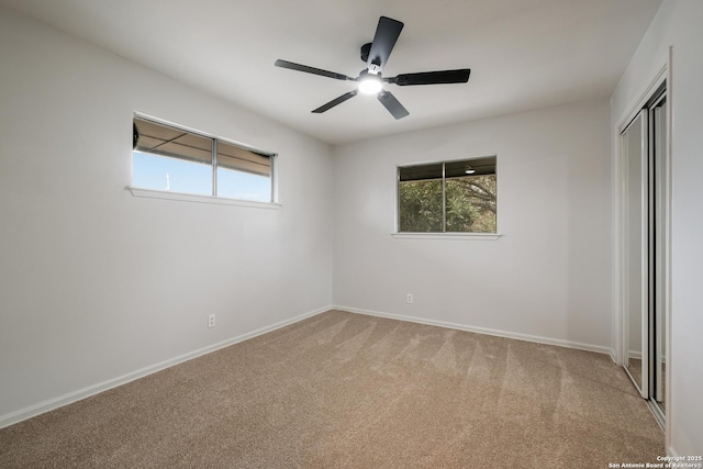 unfurnished bedroom featuring ceiling fan, a closet, and carpet