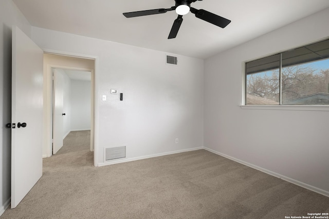 unfurnished room with ceiling fan and light colored carpet