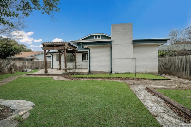 back of house with a yard, a pergola, and a patio area