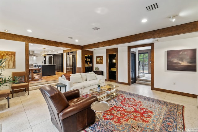 living room featuring beamed ceiling and light tile patterned floors