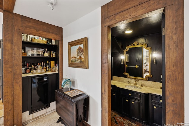 bar featuring wine cooler and sink