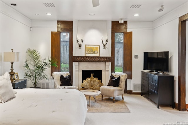 bedroom featuring multiple windows, a large fireplace, and light carpet