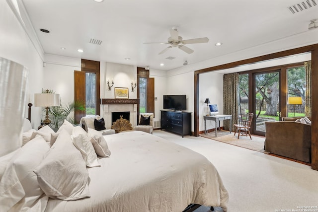 bedroom featuring crown molding, light colored carpet, a fireplace, and access to outside