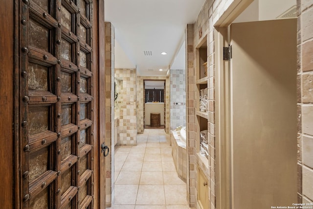 wine area featuring tile walls and light tile patterned floors