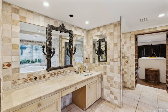 bathroom featuring tile patterned flooring, vanity, and tile walls