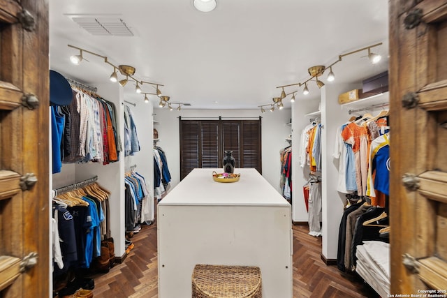 walk in closet featuring dark parquet floors